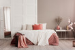 © Photographee.eu - Orange pillows on white king size bed in fashionable female bedroom