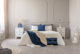 Fototapeta  - New york style bedroom interior with symmetric design, copy space on empty grey wall