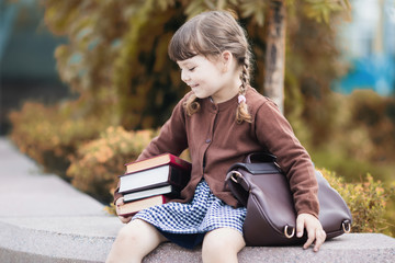 Preschool girl reading books. Little genius concept