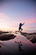 © Stephen Simpson/Tetra Images - Teenage boy jumping between rocks of tide pool in La Jolla, California