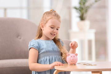 Poster - Little girl with piggy bank and money at home