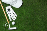 Flat lay composition with golf equipment on artificial grass, space for text