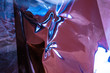 © Katia - Holographic plastic wrinkled film with contrast sun light reflections. Blue tones with dark black shadows on metallic chrome surface. Neon light colors. Abstract fantasy trendy psychedelic background