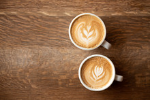 Two Cups Of Coffee On A Dark Wooden Background