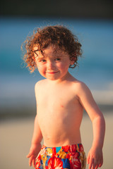 Wall Mural - Young boy playing in the surf, Cinnamon Bay, St. John, USVI