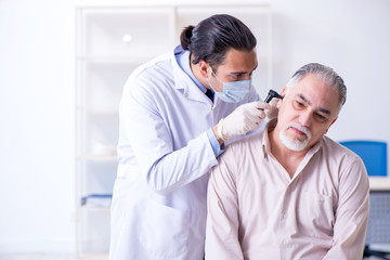 Male patient visiting doctor otolaryngologist