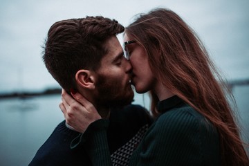 young international couple kissing near the sea in france (french / russian)