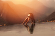 © 220 Selfmade studio - Attractive Asian woman practice yoga Downward Facing Dog or Adho Mukha Svanasana pose on the pool above the Mountain peak in the morning in front of beautiful nature views in SAPA vietnam,Warm Tone