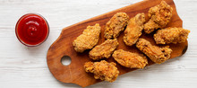 Chicken Wings On A Rustic Wooden Board With Red Pepper Sauce On A White Wooden Background. Top View, Overhead, From Above.