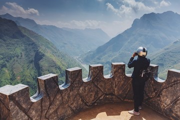 Wall Mural - Traveler woman standing on the top of mountain in nature at North Vietnam.Beautiful landscape for adventure travel.