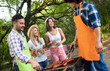 © NDABCREATIVITY - Friends having a barbecue party in nature while having fun