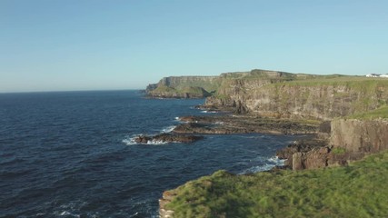 Wall Mural - Aerial Flight view of  Giant's Causeway rocks cliff area during summer sunset time Northern Ireland