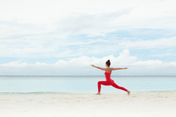 Wall Mural - Yoga outdoor. Happy woman doing yoga exercises, meditate on the beach. Yoga meditation in nature. Concept of healthy lifestyle and relaxation. Pretty woman practicing yoga near the sea