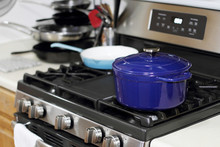 Porcelain Enameled Dutch Oven And Skillet On The Stove Top In A Home Kitchen.