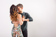 © satura_ - Social dance concept - Active happy adults dancing bachata or tango together over white background with copy space