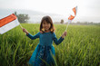 happy indonesian kid with national flag outdoor