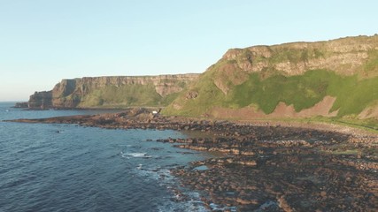 Wall Mural - Aerial Flight view of  Giant's Causeway rocks cliff area during summer sunset time Northern Ireland