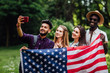 © Тарас Нагирняк - Preety teenagers make a selfie with american flag, celebrating 4th july - Independence Day.