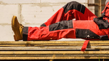 Person Wearing Red Worker Trousers