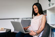 © bnenin - Beautiful brunette woman using laptop at home.