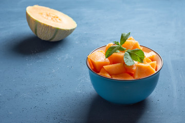 Fresh melon cut into pieces in a bowl - image