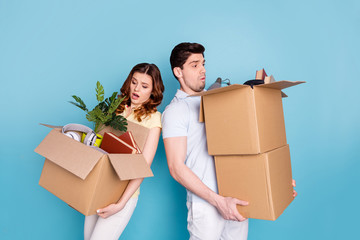 Portrait of his he her she nice-looking attractive sad unhappy upset worried nervous people carrying big large boxes packages isolated over bright vivid shine blue green background