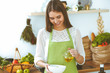 © rogerphoto - Young happy woman cooking in the kitchen. Healthy meal, lifestyle and culinary concepts. Good morning begins with fresh salad