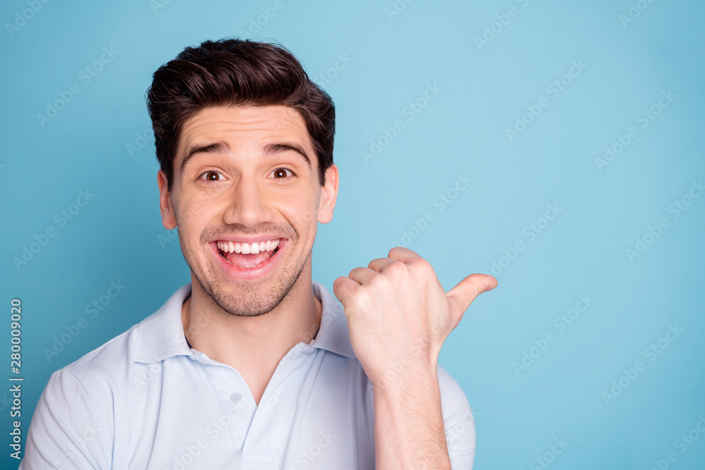 Close-up portrait of his he nice attractive cheerful cheery guy wearing casual pointing aside ad sale discount isolated over bright vivid shine blue green background - obrazy, fototapety, plakaty 