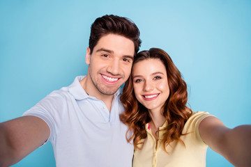 Wall Mural - Close up photo of foxy lady brunet guy pair making selfies toothy beaming smile wear casual t-shirts isolated blue background