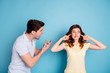 © deagreez - Photo of angry brother yell sister scolding for spoiling video game records wear casual t-shirts isolated blue background