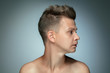 © master1305 - Profile portrait of shirtless young man isolated on grey studio background. Caucasian healthy male model looking at side and posing. Concept of men's health and beauty, self-care, body and skin care.