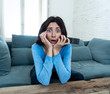 © SB Arts Media - Portrait of a young woman looking scared and shocked watching TV. Human expressions and emotions