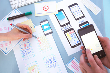 Wall Mural - designer developer of applications for mobile phones at the desktop. user experience. creation of an