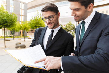 Wall Mural - Two attractive young businessmen wearing suits