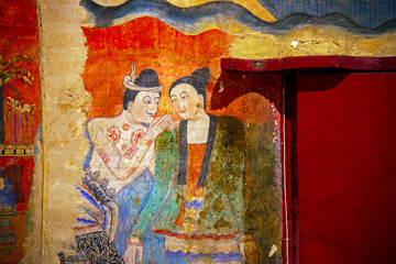 NAN ,THAILAND - July 22  Traditional Thai mural painting on temple wall at Wat Phumin  Nan, Thailand. The famous mural painting of a man whispering to the ear of a woman.