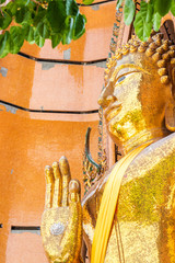 Wall Mural - Big golden buddha statue in Kanchanaburi province, Thailand.