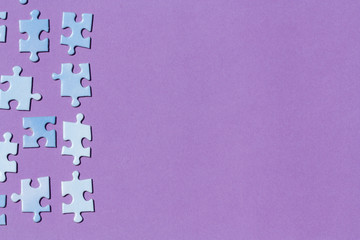 Puzzle pieces on a purple background.