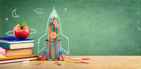 back to school - books and pencils with rocket sketch