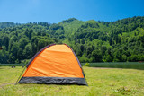 Fototapeta  - Camping tent at scenic campsite on a lake