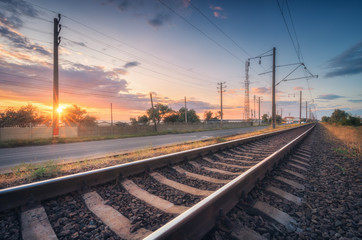 Wall Mural - railroad and beautiful sky at sunset in summer. rural industrial landscape with railway station, blu