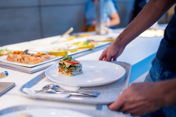 man picks up food at the buffet