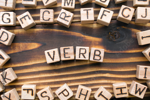 word verb composed of wooden cubes with letters, Part of speech concept scattere Poster Mural XXL