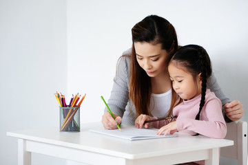 Learning Asian kid girls are practicing drawing skills in the classroom. To create imagination, knowledge, and brain development for children And also helps to use hand skills in small muscle bundles