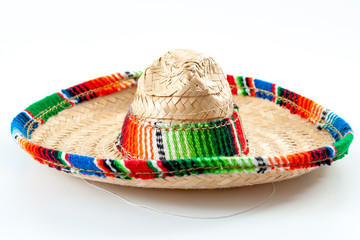 Cinco de mayo, traditional mexican hat and caribbean culture concept theme with close up on wicker or straw sombrero decorated in bright colors isolated on white background