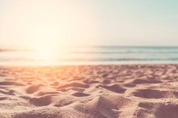 Wall Mural - copy space of soft sand sea and blur tropical beach with sunset sky and cloud abstract background.