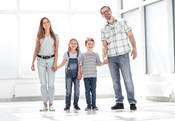 Wall Mural - happy parents with children standing in a new apartment