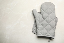 Oven Mitt, Pot Holder And Space For Text On Light Stone Background, Flat Lay