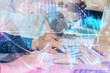 © peshkova - Double exposure of businessman working on laptop on background. International business hologram in front. Concept of success.