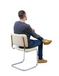 © ghoststone - Side view of a man sitting on a chair.
