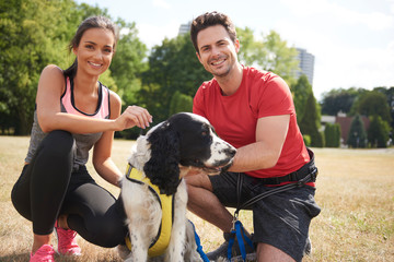 Wall Mural - Smiling couple and dog after workout on the fresh air